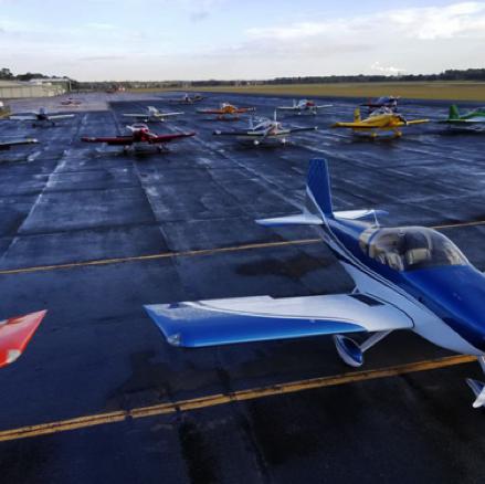 Aircraft belonging to members of the Experimental Aircraft Association are parked in formation.